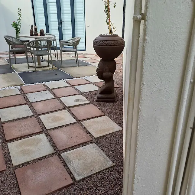 African-inspired courtyard with patterned paving, container planting and a private outdoor seating area